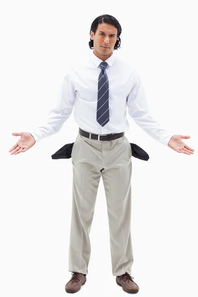 Portrait of an innocent businessman showing his empty pockets — Stock Photo, Image