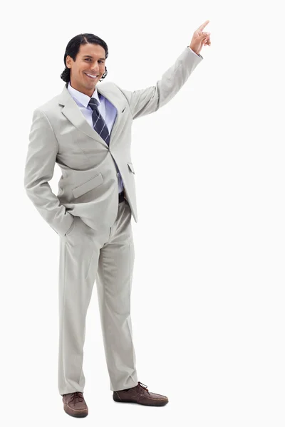 Portrait of a smiling businessman pointing at a copy space — Stock Photo, Image