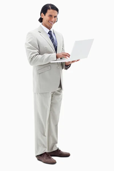 Portrait of a smiling businessman using a notebook — Stock Photo, Image