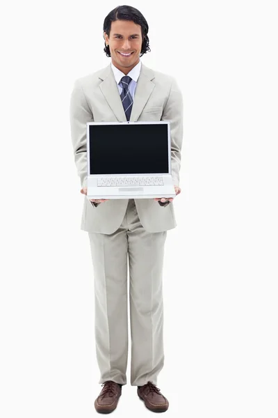 Portrait of a smiling businessman showing a notebook — Stock Photo, Image