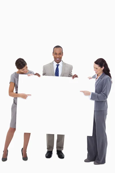 Businesspeople pointing at blank sign in their hands — Stock Photo, Image