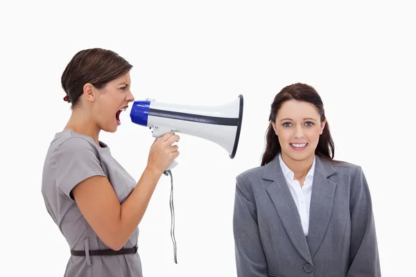 Businesswoman using megaphone to yell at colleague — Stock Photo, Image