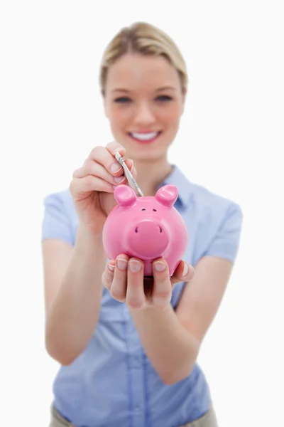 Note being put into piggy bank by woman — Stock Photo, Image