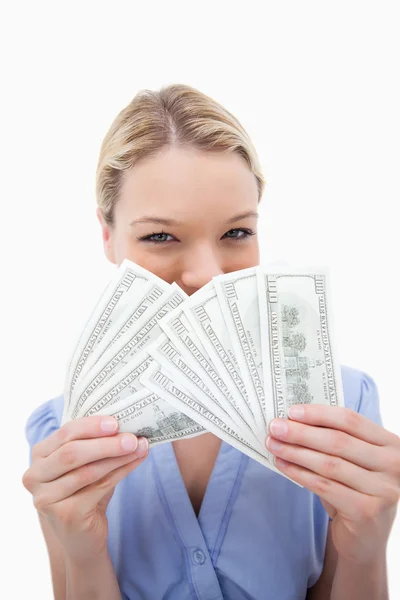Woman hiding behind bank notes — Stock Photo, Image