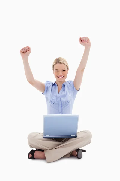 Woman with laptop raising her hands — Stock Photo, Image