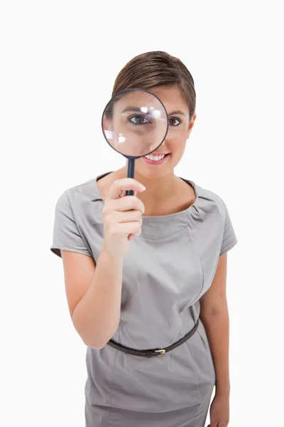 Woman using magnifier — Stock Photo, Image