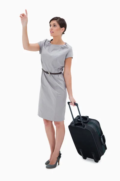 Woman with wheely bag calling a taxi — Stock Photo, Image