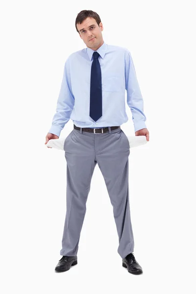 Broke businessman showing his empty pockets — Stock Photo, Image