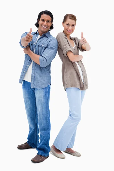 Smiling couple giving thumbs up — Stock Photo, Image