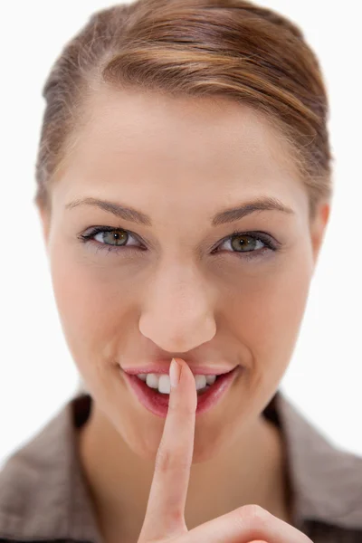 Smiling woman asking for silence — Stock Photo, Image