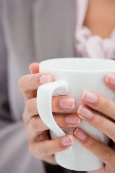 Cup being held by female hands — Stock Photo, Image