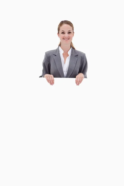 Bank employee holding blank sign in her hands — Stock Photo, Image