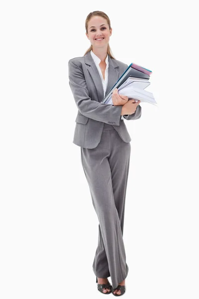 Smiling office employee with pile of paperwork — Stock Photo, Image