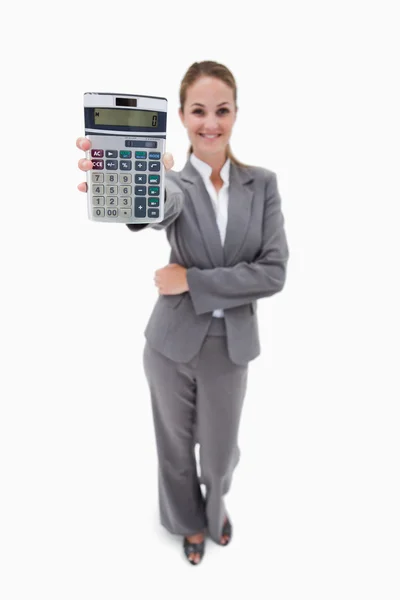 Smiling bank employee showing pocket calculator — Stock Photo, Image