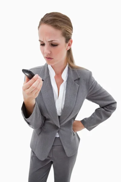 Irritated bank employee reading text message — Stock Photo, Image