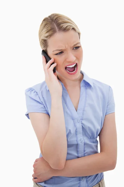 Woman yelling into her phone Stock Image