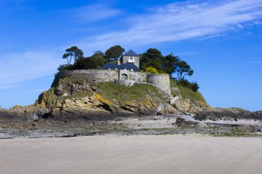 Landscape, seascape with beach and a house on top of a rock. clipart