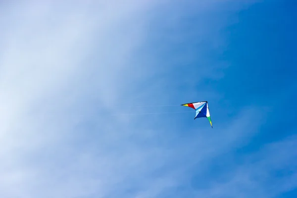 stock image Colorful kite soaring in a nice blue sky