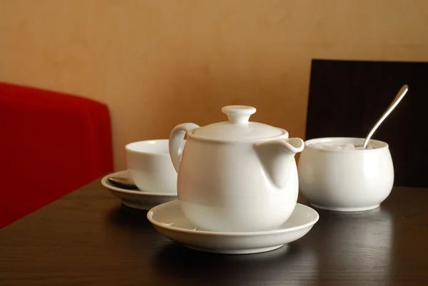 Stock image Teapot with cup in a restaurant interior