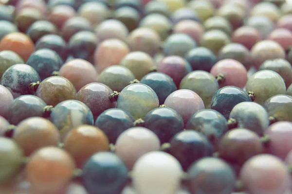 Beads from a multi-colored stone — Stock Photo, Image