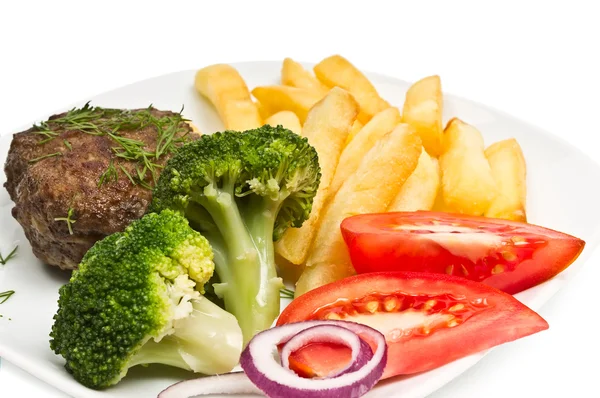Costeleta com endro, batatas fritas, tomate e brócolis — Fotografia de Stock
