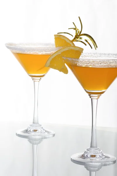 A close-up of martini glass with orange cocktails and a piece of citrus — Stock Photo, Image
