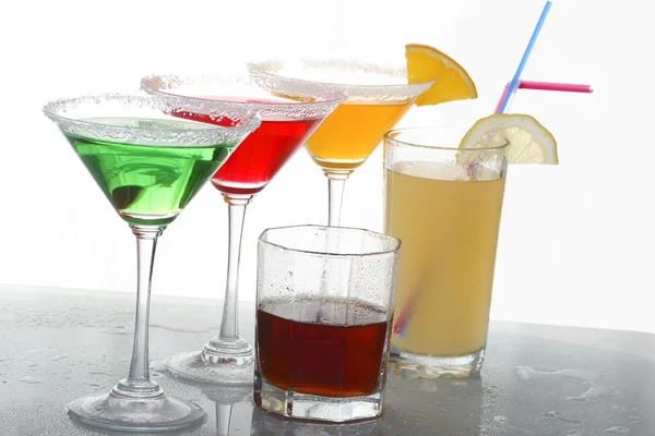 A close up view of martini glass with different colored cocktails and whisky — Stock Photo, Image
