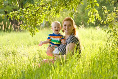 Happy mother and her baby with Down's syndrome clipart