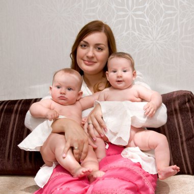 Mother hugging baby twins clipart