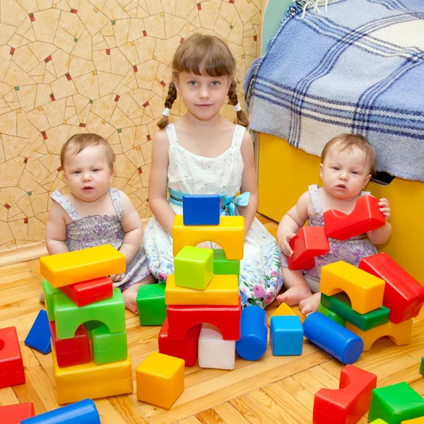 Preschooler and two twins baby building of blocks — Stock Photo, Image