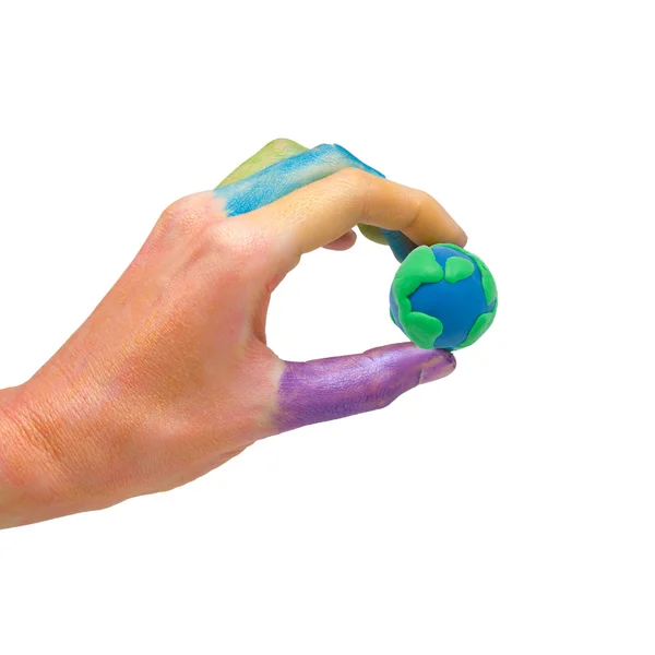 stock image Colorful paints hand is holding the globe