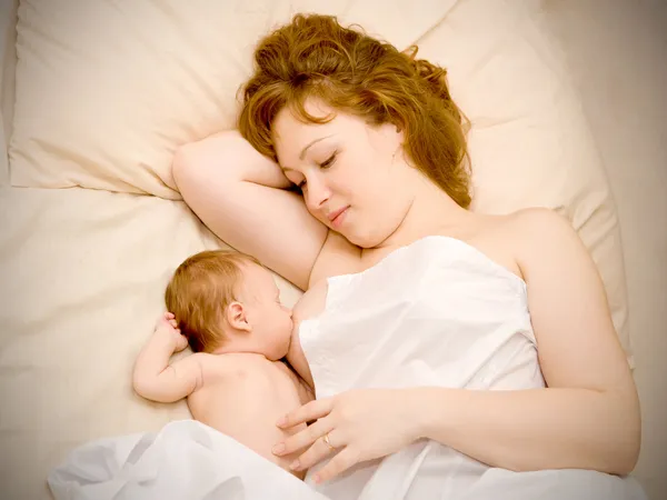 Newborn baby is breast-feeding — Stock Photo, Image