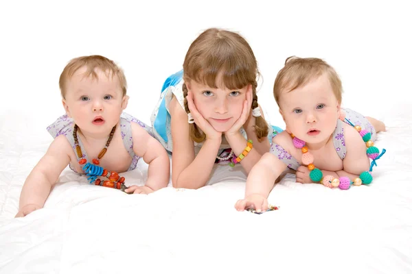 Tres hermanas gemelas y una colegiala —  Fotos de Stock