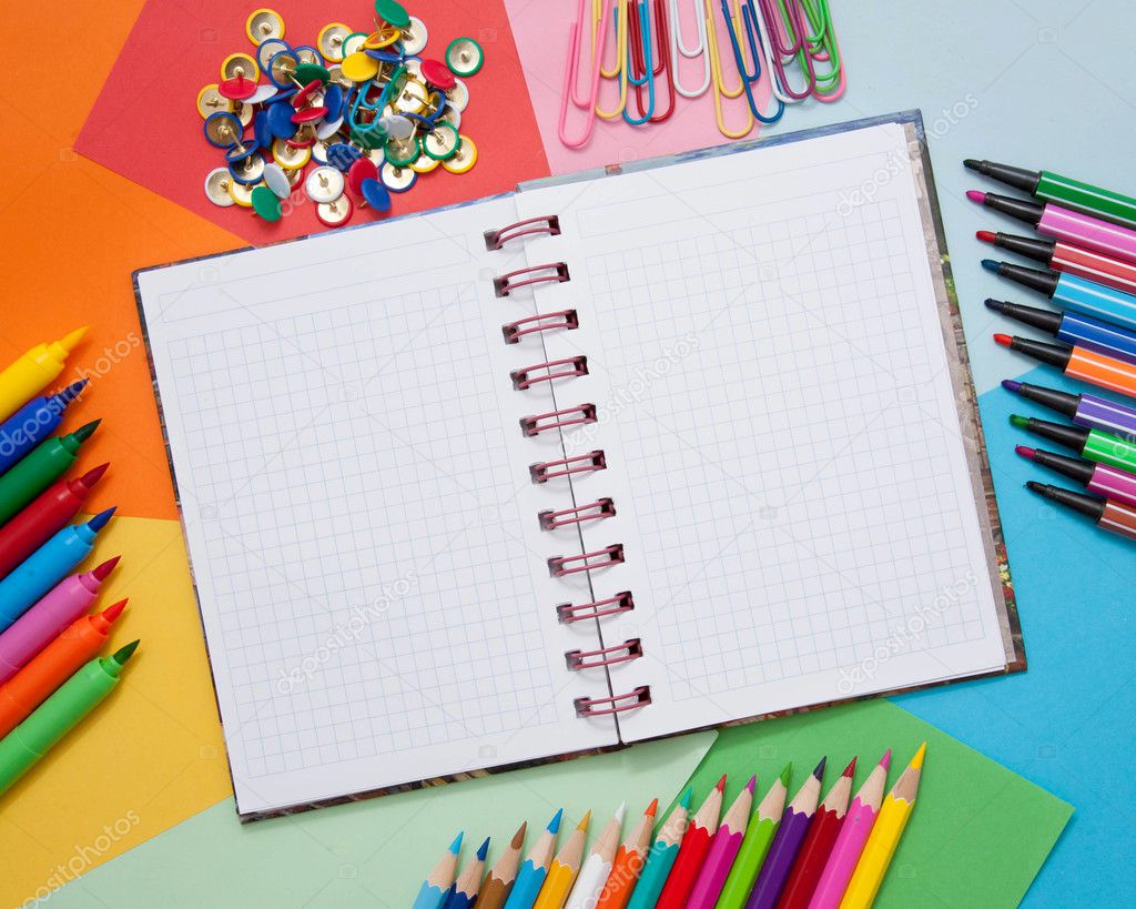 School, office, or artistic accessories - open notebook, colored paper, colored pencils, markers, paper clips, buttons
