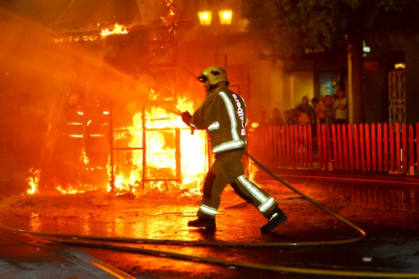 Pompier éteint le feu Images De Stock Libres De Droits