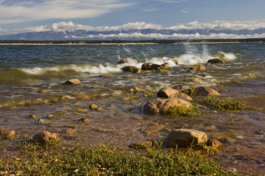 Waves crashing on the shore of lake