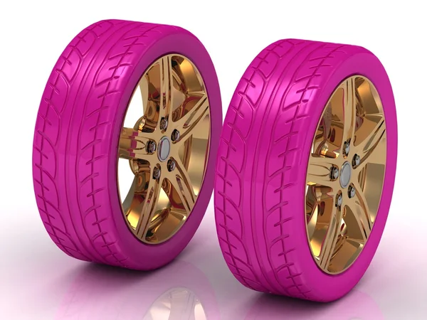 2 pink wheels with a gold disc — Stock Photo, Image