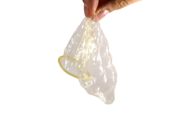 Desembalado preservativo em homens dedos Imagem De Stock