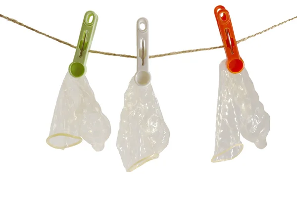 Três preservativos na corda Fotografia De Stock