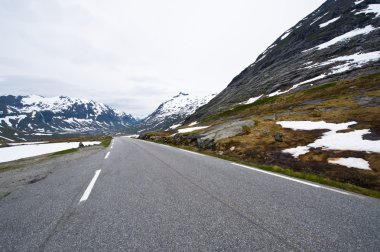 Norway road landscape on high mountains. clipart