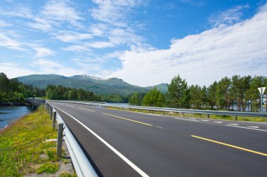 Norway road landscape. Rain on road. clipart