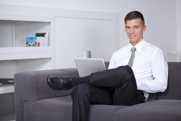 Successfull businessman working with a notebook and sitting — Stock Photo, Image