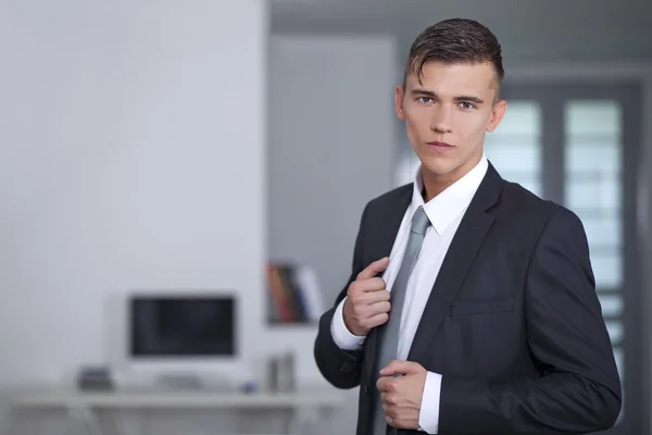 Uomo d'affari in giacca e cravatta posa tirando i revers tuta — Foto Stock