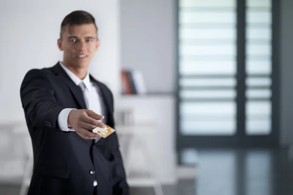 Young successful businessman holding an credit card — Stock Photo, Image