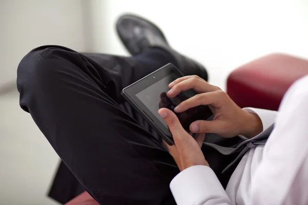 stock image Young businessman holding and touching a digital tablet