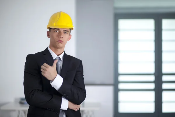 Successful businessman with yellow helmet poses and hand gesturi — Stock Photo, Image