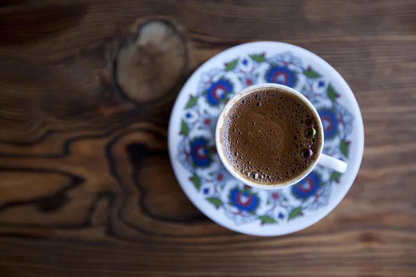 Traditional Turkish coffee served in cup on wooden table — Stock Photo, Image