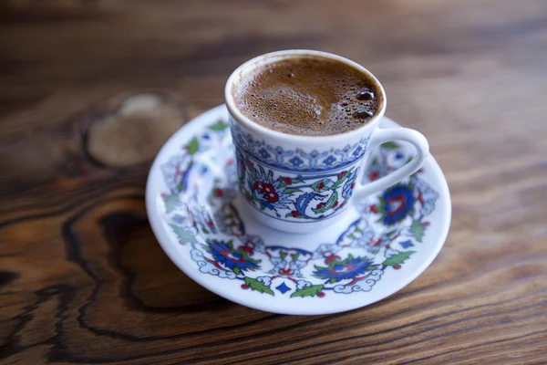 stock image Traditional Turkish coffee served in cup on wooden table