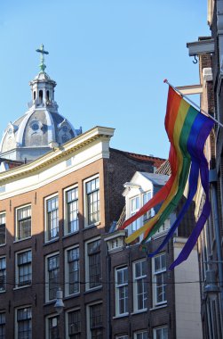 Gay flag waving , Amsterdam , Netherlands ( Holland ) clipart