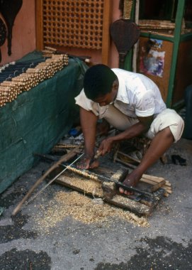 MARRAKECH, MOROCCO – AUGUST, 1979: A craftsman makes handles f